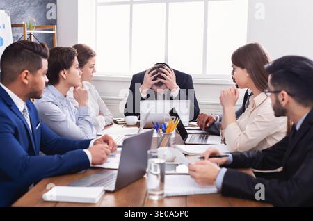 Stressed boss having problem at business meeting Stock Photo