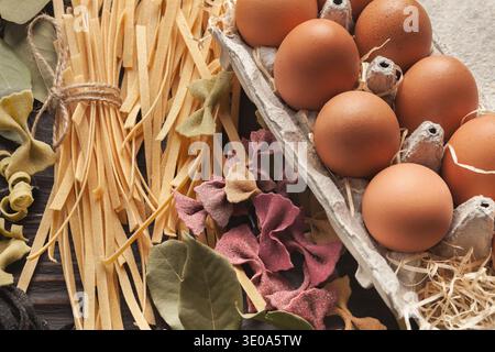 Collection of Eggs and Pasta Arranged on a Wooden Table for Cooking Stock Photo