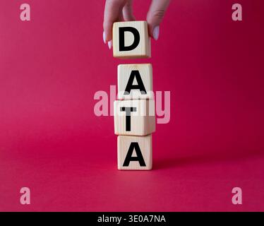 Data symbol. Concept word Data on wooden cubes. Businessman hand. Beautiful red background. Business and Data concept. Copy space. Stock Photo