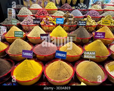 Signs mark the various spices and seasonings on display in one of the market stalls in the Deira spice market in Dubai. Stock Photo