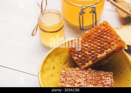 Jar full of fresh honey and honeycombs on white Stock Photo