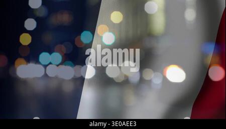 Vertical video: Waving woven tricolor fabric over night bokeh, cars causing breeze and light blobs Stock Photo