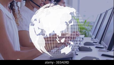 Working support team wearing light tops, headsets taking calls at desk with monitors, globe overlay Stock Photo