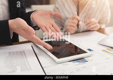 Business colleagues working on digital tablet Stock Photo
