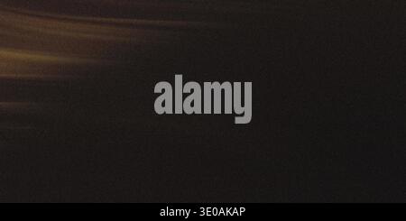 A close-up, abstract texture featuring a dark brown, slightly grainy surface with faint, horizontal golden light streaks visible on the left side, sug Stock Photo