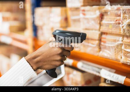 Worker scanning goods in warehouse for inventory management Stock Photo