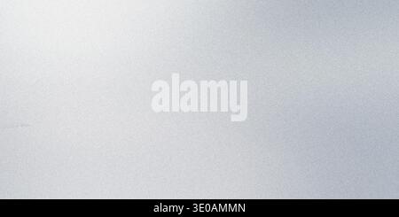 A close-up abstract background featuring a fine, grainy silver texture with a bright, soft light source emanating from the upper left corner, creating Stock Photo