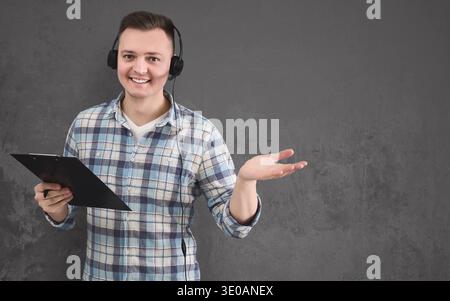 Young smiling man with headset, copy space Stock Photo
