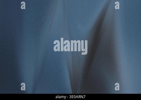 A detailed view of a deep blue, slightly grainy material, showing soft, undulating folds and darker areas where shadows accumulate, suggesting a rich Stock Photo