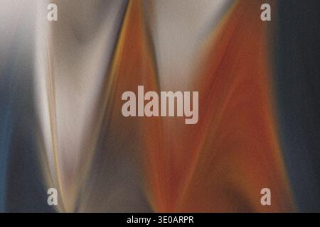 An abstract macro shot focusing on a textured surface, possibly sand or fabric, displaying a blend of bright orange, muted white/grey, and deep dark a Stock Photo
