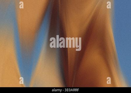 A highly detailed, abstract close-up photograph capturing the textured surface of sand dunes, featuring striking contrasts between warm brown/ochre to Stock Photo