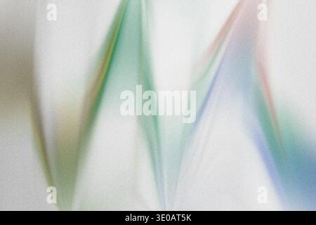A dynamic abstract image showcasing zigzagging lines in green, blue, and hints of red, overlaid on a textured, light background, creating an energetic Stock Photo