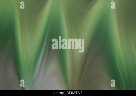 A close-up, abstract view of textured green sand, showing undulating patterns and variations in color due to light and shadow, resembling miniature du Stock Photo