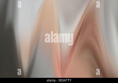 An abstract image showcasing a heavily textured, grainy surface with a blend of soft orange/peach tones against a cooler gray background. The composit Stock Photo