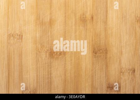 Background photo texture of a bamboo wood cutting desk with knife scratches, top view, flat lay backdrop Stock Photo