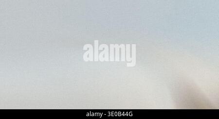 A subtle gray speckled texture creates a neutral and versatile background for various design applications Stock Photo