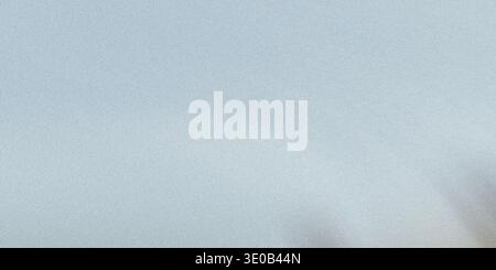 A subtle gray speckled texture creates a neutral and versatile background for various design applications Stock Photo