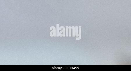 A subtle gray speckled texture creates a neutral and versatile background for various design applications Stock Photo