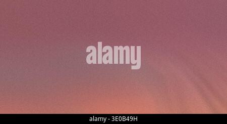 A gradient of pink and orange creates an abstract background with a subtle grainy texture Stock Photo