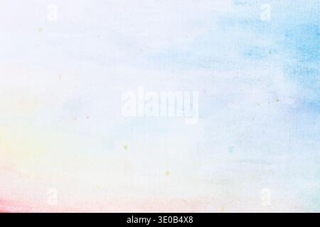 Close-up of hand painted faded light blue, yellow and orange watercolor background with watercolour stains and splashes. Textured paper background. Stock Photo