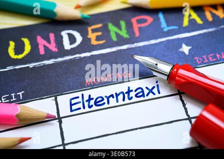 School fountain pen and timetable with the inscription Elterntaxi, photomontage Stock Photo