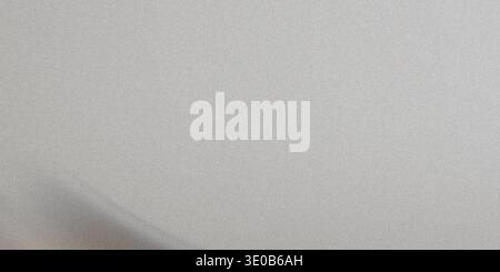 A subtle gray metallic texture creates a versatile and neutral background with a smooth, grainy surface Stock Photo