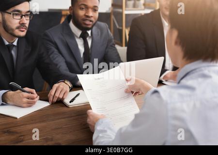 Female candidate holding resume during interview Stock Photo