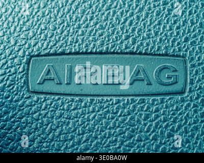 Close-up shows embossed word on textured surface. Teal hue gives sleek, modern feel. Details reveal material grain and crisp lettering. Suggests safet Stock Photo