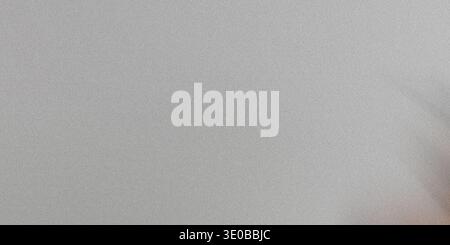A subtle gray grainy texture creates a versatile abstract background with a rough, vintage feel Stock Photo