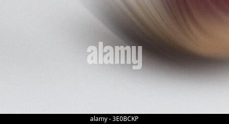 A softly blurred abstract background features a subtle gradient of light and shadow, creating a smooth and textured surface Stock Photo