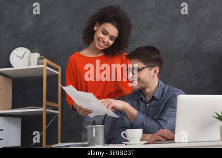 Couple of young colleagues work at modern office Stock Photo