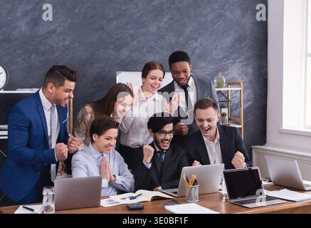 Happy multiracial managers successfuly completed hard project Stock Photo