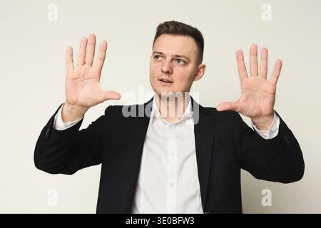 Young businessman using virtual screen for work Stock Photo