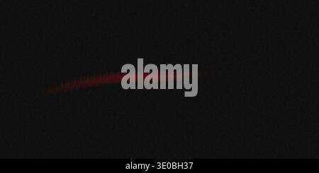 A vibrant red light streak blurs across a dark, grainy background, suggesting speed and energy in abstract motion Stock Photo