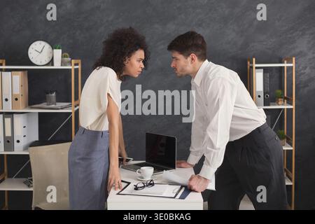 Angry people looking at each other during conflict Stock Photo