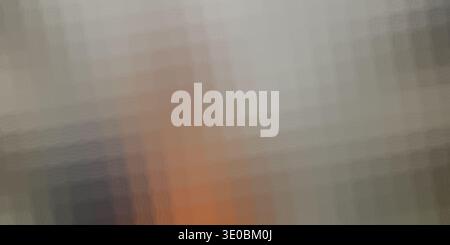 A closeup, abstract view of textured fabric with a gradient of muted colors, featuring subtle hints of orange and dark blue Stock Photo
