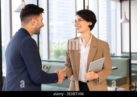Multiethnic businesspeople shaking hands after successful meeting Stock Photo