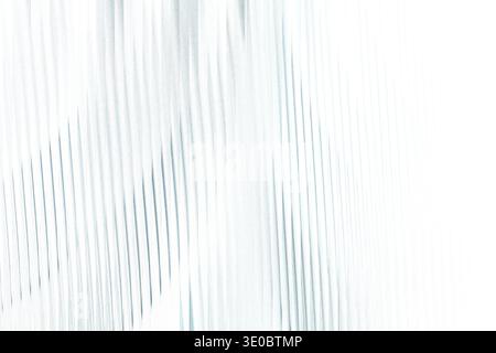 Abstract textured background with delicate vertical blue lines on a bright white canvas, creating a sense of gentle movement and light Stock Photo