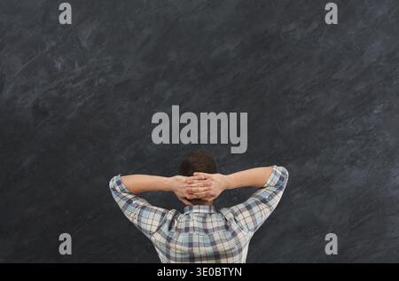 Young relaxed man in studio back view Stock Photo
