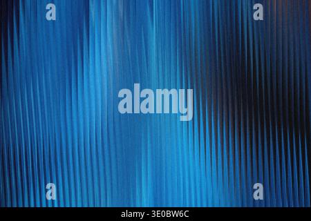 A textured blue background with vertical ribbed patterns and a gradient from bright blue to dark blue, creating a sense of depth and movement Stock Photo