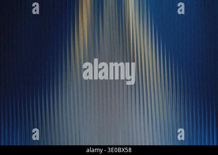 Abstract textured background with vertical lines of blue and golden hues, creating a sense of depth and movement Stock Photo