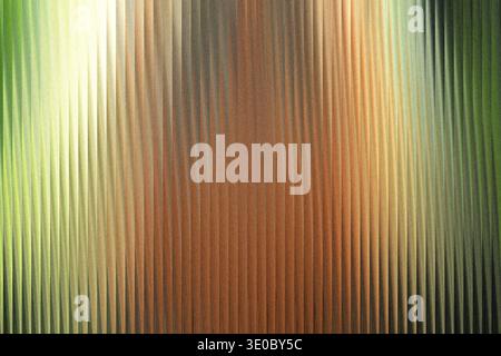 A textured background with vertical ridges, transitioning from a bright green on the left to a warm brown and then a darker green on the right, creati Stock Photo