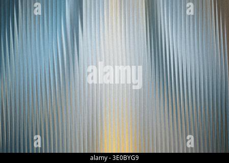 A textured abstract background with vertical ribbed patterns in shades of blue, silver, and gold Stock Photo