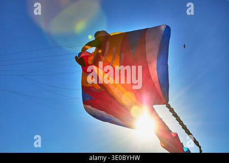 Colorful Kite Soaring with Sun Flare at Kite Festival in Las Vegas Nevada Stock Photo