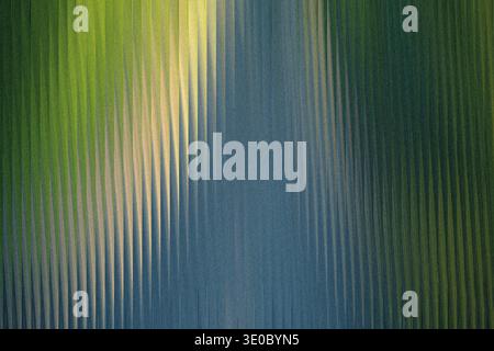 Vertical ribbed glass refracts light, creating a textured abstract background with gradients of green and blue Stock Photo
