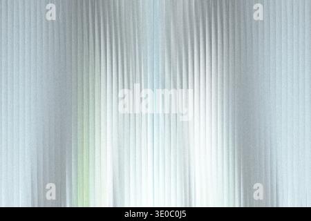 A shimmering, textured background with vertical lines and a subtle gradient of light and color, creating a futuristic or abstract effect Stock Photo