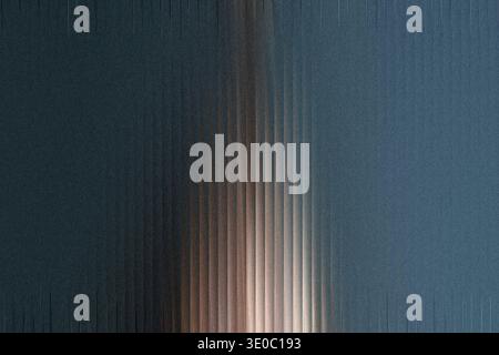 A textured, dark blue surface with vertical ribbed patterns and a warm light source illuminating the center Stock Photo