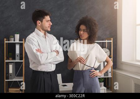 Serious business couple standing in office Stock Photo