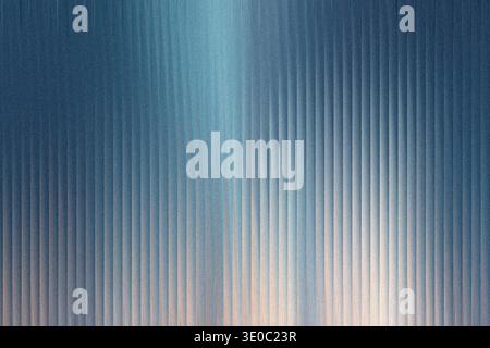 A textured background with vertical ribbed lines, transitioning from a deep blue hue at the top to a lighter, warmer tone at the bottom, creating a gr Stock Photo