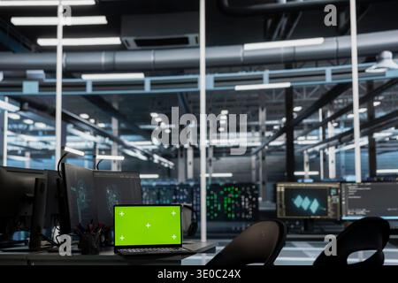 Green screen laptop and AI research workstation used for neural network training. Chroma key and computers in high tech data center infrastructure supporting deep learning operations Stock Photo
